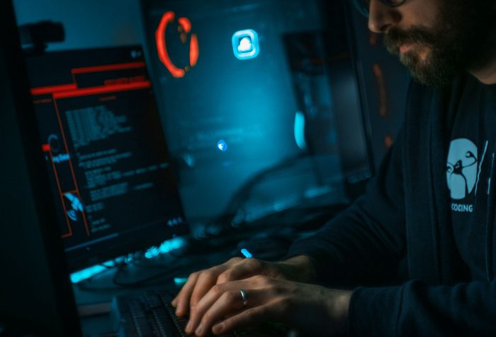 A cybersecurity professional looking at screens
